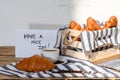 Morning message ??ave a nice day?? coffee cup and buttered fresh French croissants in a crate Royalty Free Stock Photo